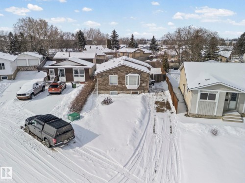 The property features a stone facade with a bay window and a private driveway - 115 Warwick Road, Edmonton, AB - Outdoor With Facade