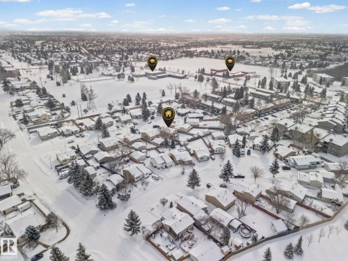 Aerial view of the neighborhood featuring a collection of properties with snow-covered roofs and surrounding grounds - 115 Warwick Road, Edmonton, AB - Outdoor With View