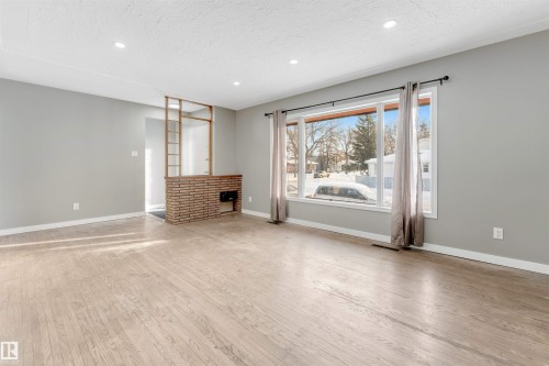Unfurnished living room featuring recessed lighting, light wood finished floors, and a textured ceiling - 12202 45 Street, Edmonton, AB - Indoor
