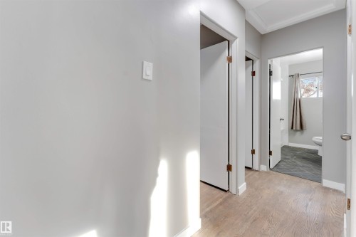 Hall with baseboards and light wood-style floors - 12202 45 Street, Edmonton, AB - Indoor Photo Showing Other Room