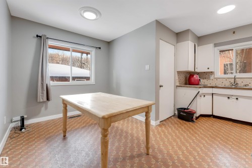 Dining space with light colored carpet and plenty of natural light - 12202 45 Street, Edmonton, AB - Indoor Photo Showing Kitchen With Double Sink