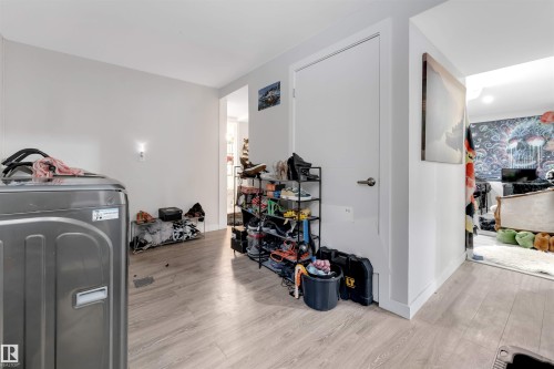 Workout room featuring washer / clothes dryer and light wood-style floors - 12202 45 Street, Edmonton, AB - Indoor Photo Showing Laundry Room