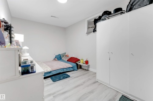 Bedroom featuring light wood-type flooring and baseboards - 12202 45 Street, Edmonton, AB - Indoor