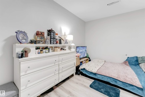 Bedroom featuring light wood-type flooring - 12202 45 Street, Edmonton, AB - Indoor Photo Showing Bedroom