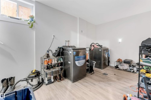 Miscellaneous room with washer / clothes dryer and wood finished floors - 12202 45 Street, Edmonton, AB - Indoor