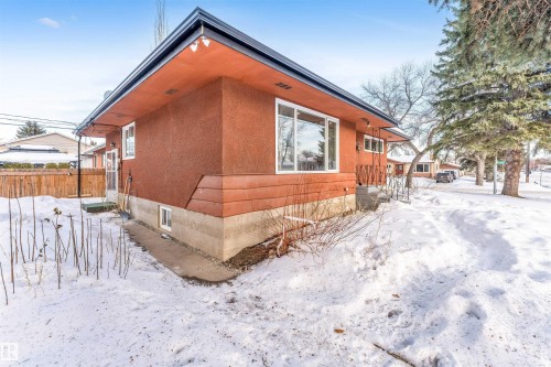 View of snow covered exterior featuring stucco siding - 12202 45 Street, Edmonton, AB - Outdoor With Exterior