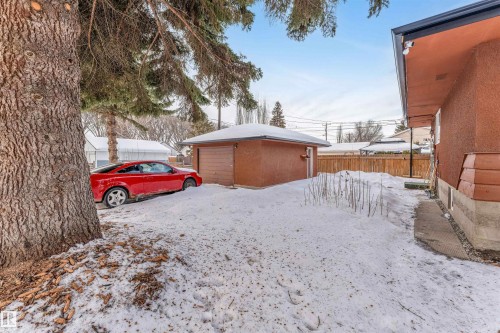 Yard layered in snow with an outdoor structure and a garage - 12202 45 Street, Edmonton, AB - Outdoor