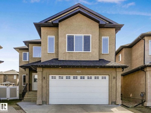 Stucco exterior featuring a two-story design with a prominent front-facing gable - 16251 135 Street Nw, Edmonton, AB - Outdoor