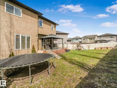 Expansive backyard featuring a manicured lawn, a raised wooden deck with a gazebo, and a privacy fence - 16251 135 Street Nw, Edmonton, AB - Outdoor With Deck Patio Veranda