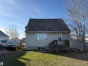 Single-family residence featuring light-colored siding and a dark shingle roof - 410 Main St, Alcomdale, AB  - Outdoor 