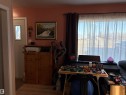 Hardwood-style flooring throughout - 410 Main St, Alcomdale, AB  - Indoor Photo Showing Other Room 