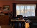 Expansive window dressed with sheer and blackout curtains - 410 Main St, Alcomdale, AB  - Indoor 
