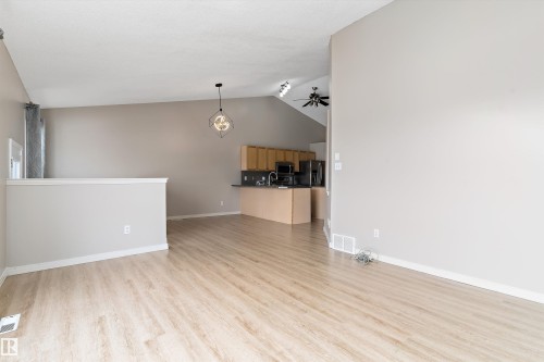Open-concept living area with wood-finish flooring - 15109 Miller Boulevard, Edmonton, AB - Indoor