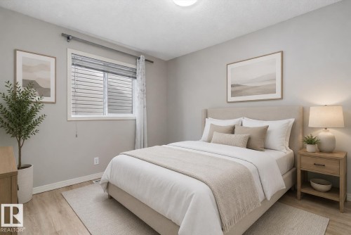 Bedroom featuring light grey walls, wood-finish flooring, and a window with blinds - 15109 Miller Boulevard, Edmonton, AB - Indoor Photo Showing Bedroom