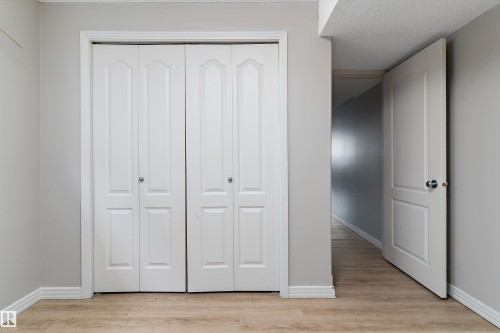 Dual bi-fold closet doors with brushed nickel hardware - 15109 Miller Boulevard, Edmonton, AB - Indoor