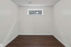 Neutral wall finishes with dark wood-finish flooring - 