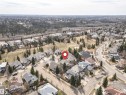 Residential streetscape featuring a detached home with a gray shingle roof and surrounding mature trees - 607 Butterworth Wynd, Edmonton, AB  - Outdoor With View 