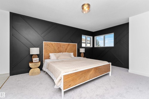 Bedroom featuring a black accent wall with geometric paneling, light-colored carpeting, and two windows providing natural light - 607 Butterworth Wynd, Edmonton, AB - Indoor Photo Showing Bedroom