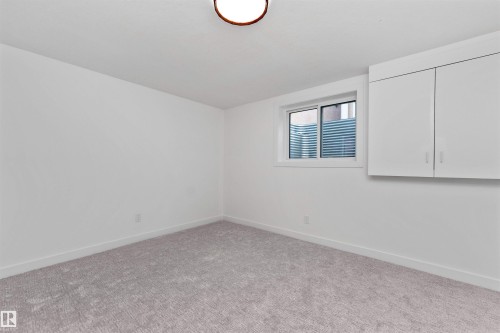 Room featuring light gray carpet flooring, white walls, and a window with horizontal blinds - 607 Butterworth Wynd, Edmonton, AB - Indoor Photo Showing Other Room