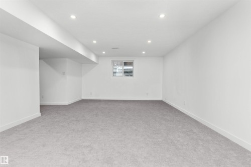 Spacious room featuring neutral carpeting, white painted walls, recessed lighting, and a white window with horizontal blinds - 607 Butterworth Wynd, Edmonton, AB - Indoor Photo Showing Other Room