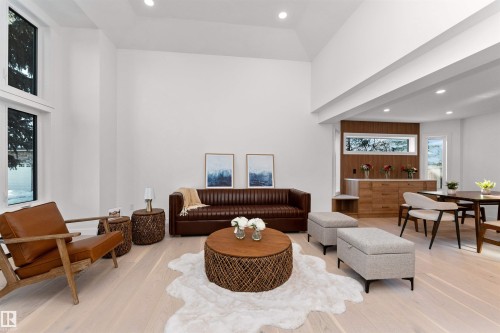 Vaulted ceiling living area with light wood-finish flooring, recessed lighting, and large windows - 607 Butterworth Wynd, Edmonton, AB - Indoor Photo Showing Living Room