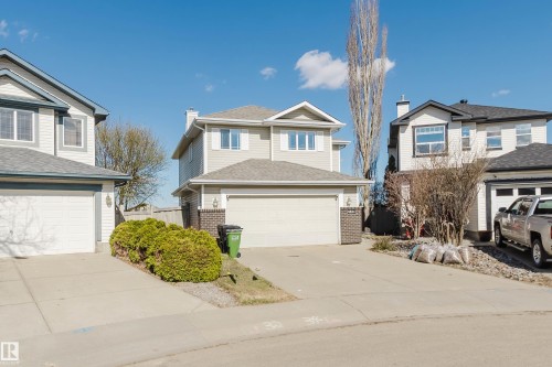 Two-story residence featuring light-colored siding, a dark roof, and an integrated two-car garage - 3534 Mclean Crescent, Edmonton, AB - Outdoor With Facade