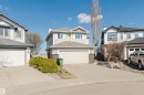 Two-story residence featuring light-colored siding, a dark roof, and an integrated two-car garage - 3534 Mclean Crescent, Edmonton, AB  - Outdoor With Facade 