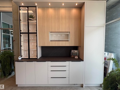 Modern cabinetry installation featuring light wood-finish upper cabinets and white lower cabinets - 9007 92 Street, Edmonton, AB - Indoor