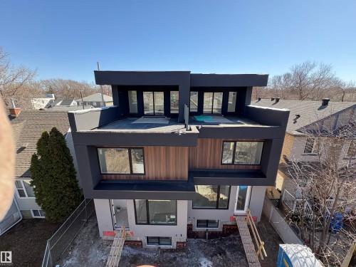 Modern multi-level exterior with dark-finished siding and wood-finish paneling - 9007 92 Street, Edmonton, AB - Outdoor
