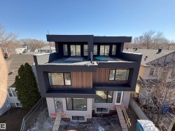 Modern multi-level exterior with dark-finished siding and wood-finish paneling - 