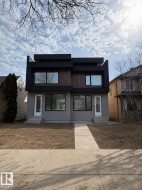 Contemporary facade featuring a combination of stucco and wood-finish siding with black trim accents - 