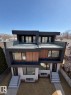 Contemporary duplex with a flat roofline, featuring a rooftop terrace with glass railings - 9007 92 Street, Edmonton, AB  - Outdoor With Facade 