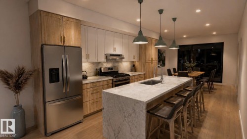 Contemporary kitchen featuring a large waterfall island with integrated sink, stainless steel appliances, two-tone cabinetry, recessed lighting, and wood-finish flooring - 9007 92 Street, Edmonton, AB - Indoor Photo Showing Kitchen With Stainless Steel Kitchen With Upgraded Kitchen