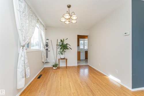Bedroom featuring wood-finish flooring, a neutral wall color, built-in wall shelves, and a ladder-style shelving unit - 11423 50 Avenue, Edmonton, AB - Indoor Photo Showing Bedroom