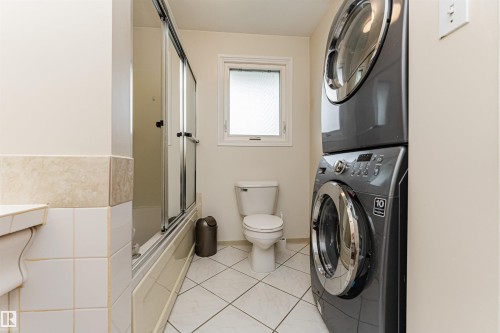 Spacious room featuring light-colored carpeting, multiple brick accent walls, and recessed lighting - 11423 50 Avenue, Edmonton, AB - Indoor Photo Showing Other Room