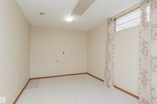 Room featuring light-colored walls and patterned carpeting - 11423 50 Avenue, Edmonton, AB - Indoor Photo Showing Other Room