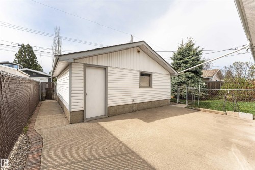Detached garage with white siding, a side entry door, and a single window - 11423 50 Avenue, Edmonton, AB - Outdoor With Exterior