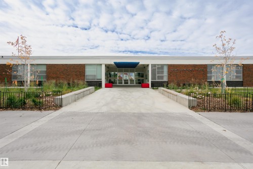 Contemporary commercial facade featuring a prominent concrete entrance ramp and walkway - 11423 50 Avenue, Edmonton, AB - Outdoor