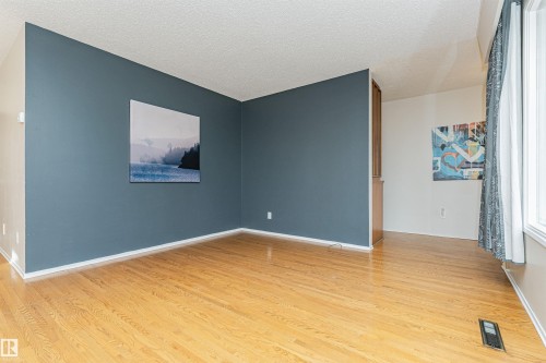 Hardwood-finish flooring throughout, featuring a multi-pane window configuration providing natural light - 11423 50 Avenue, Edmonton, AB - Indoor Photo Showing Other Room