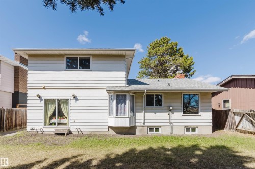 Rear exterior with light-colored horizontal siding and a multi-level roofline - 10423 35 Avenue, Edmonton, AB - Outdoor