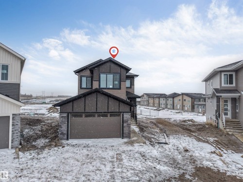 The property features a two-story exterior with a combination of horizontal siding and stone accents - 4004 35 Street, Beaumont, AB - Outdoor