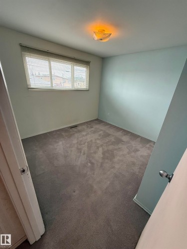 Room featuring wall-to-wall gray carpeting, light blue wall paint, and a white ceiling - 12916 95A Street, Edmonton, AB - Indoor Photo Showing Other Room
