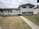 Split-level residence featuring light-colored siding, a front entry with a white door, and multiple windows - 12916 95A Street, Edmonton, AB  - Outdoor 