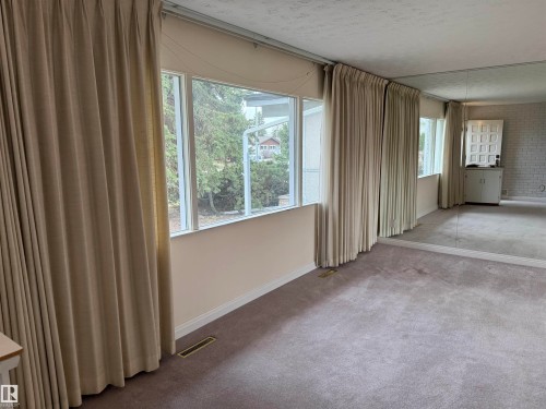 Expansive room featuring multiple windows, full-length drapes, and wall-to-wall carpeting - 12916 95A Street, Edmonton, AB - Indoor Photo Showing Other Room