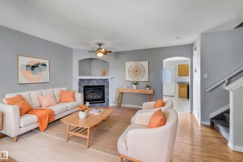 Virtually staged photo - 4316 151 Avenue, Edmonton, AB - Indoor Photo Showing Living Room With Fireplace