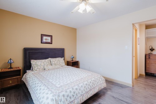 This room features wood-look flooring and a ceiling fan - 25 9926 80 Avenue, Edmonton, AB - Indoor Photo Showing Bedroom