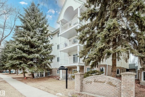 The property is a low-rise building featuring a light-colored facade with white trim and balconies - 25 9926 80 Avenue, Edmonton, AB - Outdoor With Balcony