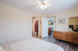 The room features light-colored walls and a ceiling fan - 