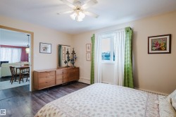 The room features dark wood flooring and a ceiling fan - 