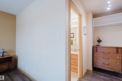 This interior space features light-colored walls and dark wood flooring - 